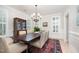 Dining room with a dark wood table, seating for six, light walls, and windows with shutters at 1414 Park Dr, Raleigh, NC 27605