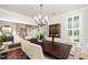 Elegant dining room featuring a dark wood table, neutral upholstered chairs, and a chandelier at 1414 Park Dr, Raleigh, NC 27605