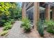 Screened porch visible from the stone path near the lushly landscaped exterior at 1414 Park Dr, Raleigh, NC 27605