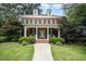 Classic brick home with a welcoming front porch and symmetrical design and manicured lawn at 1414 Park Dr, Raleigh, NC 27605