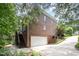 Two-story red brick home with a garage, driveway, and stairs to upper level at 1414 Park Dr, Raleigh, NC 27605
