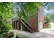 Brick home featuring an elevated deck, access stairs and stone landscaping at 1414 Park Dr, Raleigh, NC 27605
