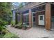 Exterior view of brick home featuring a screened in porch and landscaped yard at 1414 Park Dr, Raleigh, NC 27605