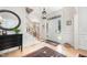 Bright foyer with hardwood floors, staircase, elegant lighting, and front door with sidelights at 1414 Park Dr, Raleigh, NC 27605