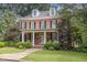 Charming brick home with a covered front porch, black shutters, dormer windows, and a green lawn at 1414 Park Dr, Raleigh, NC 27605