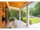 Inviting brick front porch featuring white rocking chairs and a wood ceiling at 1414 Park Dr, Raleigh, NC 27605
