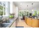 Bright kitchen with stainless steel appliances, granite countertops, and light wood floors at 1414 Park Dr, Raleigh, NC 27605