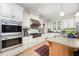 Gourmet kitchen featuring stainless steel appliances, custom cabinets, and granite countertops at 1414 Park Dr, Raleigh, NC 27605