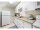 Bright kitchenette with white cabinets, modern appliances, and tile floor at 1414 Park Dr, Raleigh, NC 27605