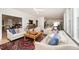 Bright living room featuring sofas with patterned pillows, a decorative rug, and a wooden coffee table at 1414 Park Dr, Raleigh, NC 27605