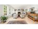 Bright living room with hardwood floors, a fireplace, built-in bookshelves, and large windows at 1414 Park Dr, Raleigh, NC 27605