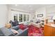 Bright living room features French doors, neutral walls and lovely, colorful area rug at 1414 Park Dr, Raleigh, NC 27605