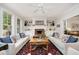 Comfortable living room featuring two sofas, a ceiling fan, and built-in bookshelves surrounding a fireplace at 1414 Park Dr, Raleigh, NC 27605