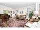 Cozy living room featuring a plush sofa, piano, and large area rug at 1414 Park Dr, Raleigh, NC 27605