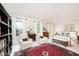 Well-lit main bedroom showcasing a seating area, brass bed, and ample natural light at 1414 Park Dr, Raleigh, NC 27605