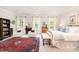 Bright main bedroom with large windows, brass bed, and two chairs at 1414 Park Dr, Raleigh, NC 27605