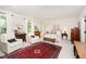 Spacious main bedroom featuring a brass bed, white armchairs, and plenty of natural light at 1414 Park Dr, Raleigh, NC 27605