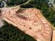 New development site showing construction progress, roads, and site layout near established homes and woodland at 147 Rivulet Ct, Cary, NC 27519