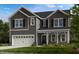 Two-story home featuring gray siding, a two-car garage, and well-maintained front lawn at 147 Rivulet Ct, Cary, NC 27519