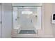 Glass enclosed shower with tile surround, mosaic floor, bench and built in niche at 147 Rivulet Ct, Cary, NC 27519