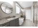 Bathroom showcasing double vanities, a freestanding tub, and a glass-enclosed shower at 15 Willow Bend Dr, Youngsville, NC 27596