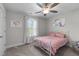 Bright bedroom with a ceiling fan, cozy bed, and whimsical wall art at 15 Willow Bend Dr, Youngsville, NC 27596