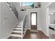 Welcoming foyer with hardwood floors, staircase, large window, and stylish front door, making a great first impression at 15 Willow Bend Dr, Youngsville, NC 27596