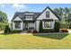 Charming home featuring a manicured lawn, crisp white siding, and dark accents at 15 Willow Bend Dr, Youngsville, NC 27596