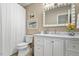 Clean bathroom featuring a white vanity, updated fixtures, and modern decor at 1523 Oak Forest Dr, Hillsborough, NC 27278