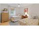 Inviting bedroom featuring twin beds, natural light, and hardwood floors at 1523 Oak Forest Dr, Hillsborough, NC 27278