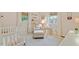Adorable Bedroom featuring soothing colors, a crib, and a comfortable reading nook at 1523 Oak Forest Dr, Hillsborough, NC 27278