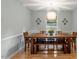 Warm dining room featuring a large wooden table, bench seating, and modern light fixture at 1523 Oak Forest Dr, Hillsborough, NC 27278