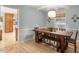 Inviting dining room with a large wooden table, bench seating, and modern light fixture at 1523 Oak Forest Dr, Hillsborough, NC 27278