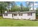 Charming single-story home featuring a well-maintained lawn and freshly painted exterior at 1523 Oak Forest Dr, Hillsborough, NC 27278