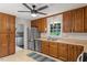 Functional kitchen features stainless steel appliances, wood cabinets, and lots of storage at 1523 Oak Forest Dr, Hillsborough, NC 27278