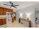 Bright kitchen featuring a black ceiling fan, white appliances and adjacent dining area at 1523 Oak Forest Dr, Hillsborough, NC 27278