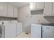 Convenient laundry room with washer, dryer, extra refrigerator and storage cabinets at 1523 Oak Forest Dr, Hillsborough, NC 27278
