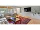 Comfortable living room with a sectional sofa, built-in cabinets, and a mounted TV at 1523 Oak Forest Dr, Hillsborough, NC 27278