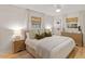 Well-lit main bedroom showcasing hardwood floors and a neutral color scheme at 1523 Oak Forest Dr, Hillsborough, NC 27278