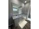 Bathroom with granite countertops, dual sinks, and modern fixtures at 154 Oakfield Trace Dr, Four Oaks, NC 27524