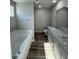 Bathroom featuring a tub, commode, and double sink vanity with granite countertops at 154 Oakfield Trace Dr, Four Oaks, NC 27524