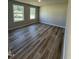 Bright bedroom with wood-style flooring and large windows that offer plenty of natural light at 154 Oakfield Trace Dr, Four Oaks, NC 27524