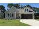 Charming single-Gathering home featuring a two-car garage, well-manicured lawn, and neutral color palette at 154 Oakfield Trace Dr, Four Oaks, NC 27524