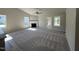 Bright living room featuring high ceilings, a cozy fireplace, and neutral walls for a modern aesthetic at 154 Oakfield Trace Dr, Four Oaks, NC 27524