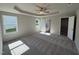 Spacious main bedroom featuring tray ceilings, ceiling fan, and ensuite bathroom entrance at 154 Oakfield Trace Dr, Four Oaks, NC 27524