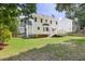 This backyard features a deck, green lawn, and a white two-story home at 16 Cedar Hill Dr, Durham, NC 27713