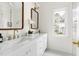 Elegant bathroom featuring double sinks, marble countertop, and modern fixtures at 16 Cedar Hill Dr, Durham, NC 27713