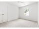 This bright bedroom features neutral carpet, a ceiling fan, and a closet at 16 Cedar Hill Dr, Durham, NC 27713