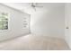 This bedroom features neutral carpet, two bright windows, and a ceiling fan at 16 Cedar Hill Dr, Durham, NC 27713