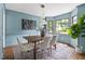 Elegant dining room featuring a large window, stylish lighting, and comfortable seating at 16 Cedar Hill Dr, Durham, NC 27713
